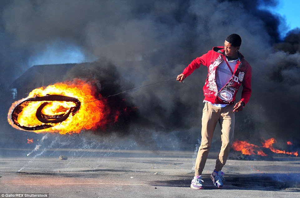 Up in flames: The protests broke out just after 6am yesterday over the closure of 33 schools across the city due to a shortage of teachers