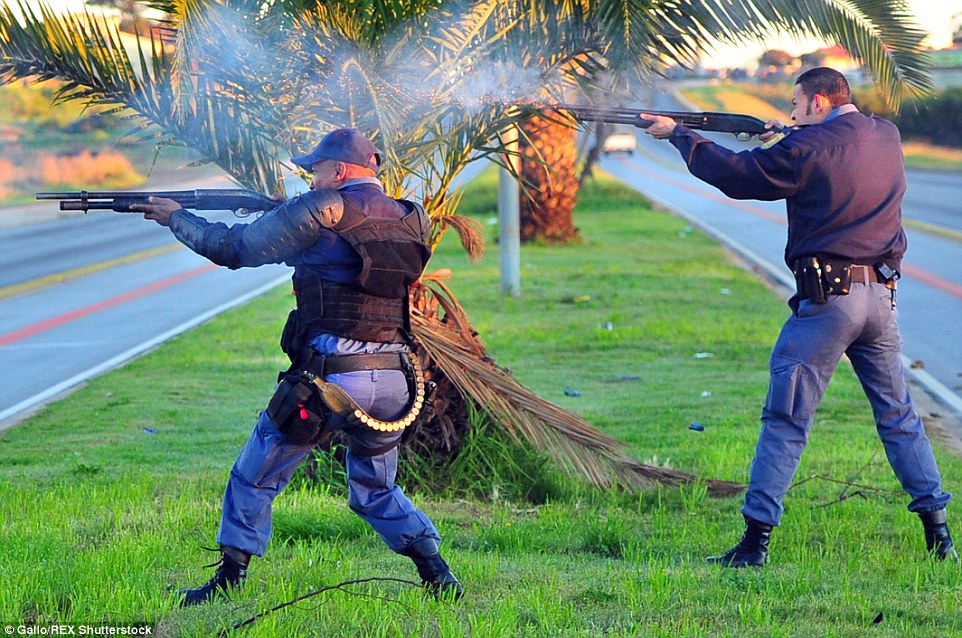 Tactical response units (above) were deployed to bring the violence under control with water cannon, stun grenades and rubber bullets